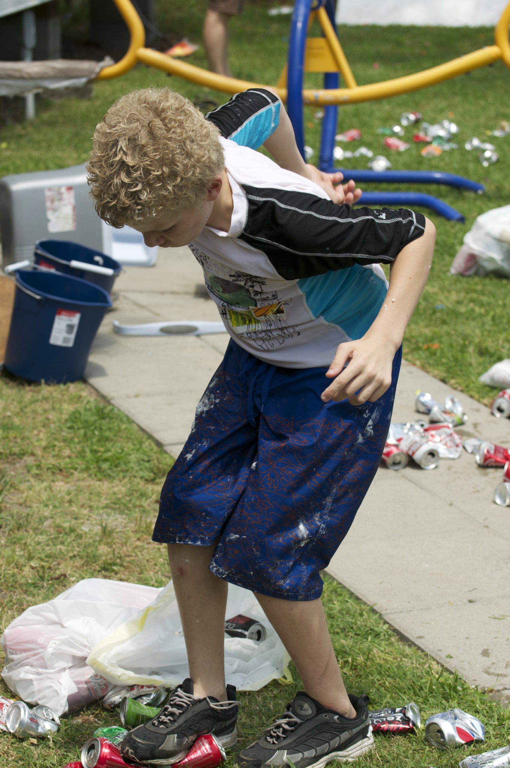 Child with Giant Axonal Neuropathy (GAN) picking up trash